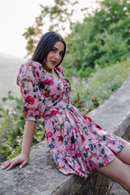 Model in the Molly Mini dress in Ambrosia Floral mauve pink, with the gathered Natalie bodice and long sleeves, by Pinup Girl Clothing