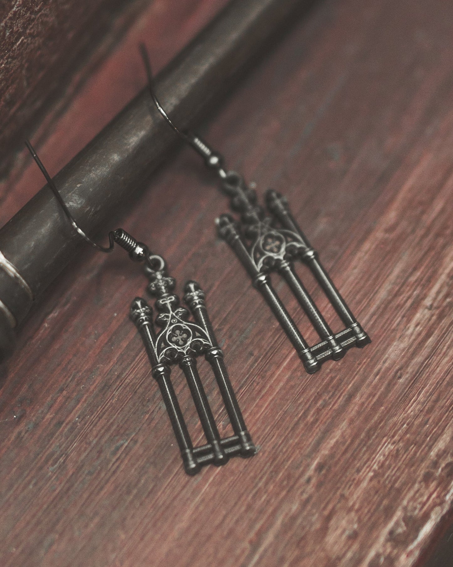 Pair of antiqued silver Cemetery Walks gate earrings laid flat, The Pretty Cult