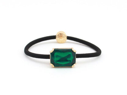 Crown Jewel ponytail hair tie with an emerald green crystal, by Pinup Girl Clothing