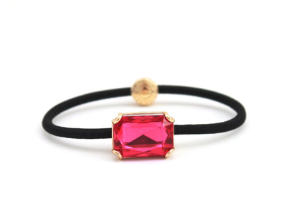 Crown Jewel ponytail hair tie with a fuchsia pink crystal, by Pinup Girl Clothing