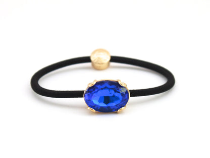 Crown Jewel ponytail hair tie with a cobalt blue crystal, by Pinup Girl Clothing