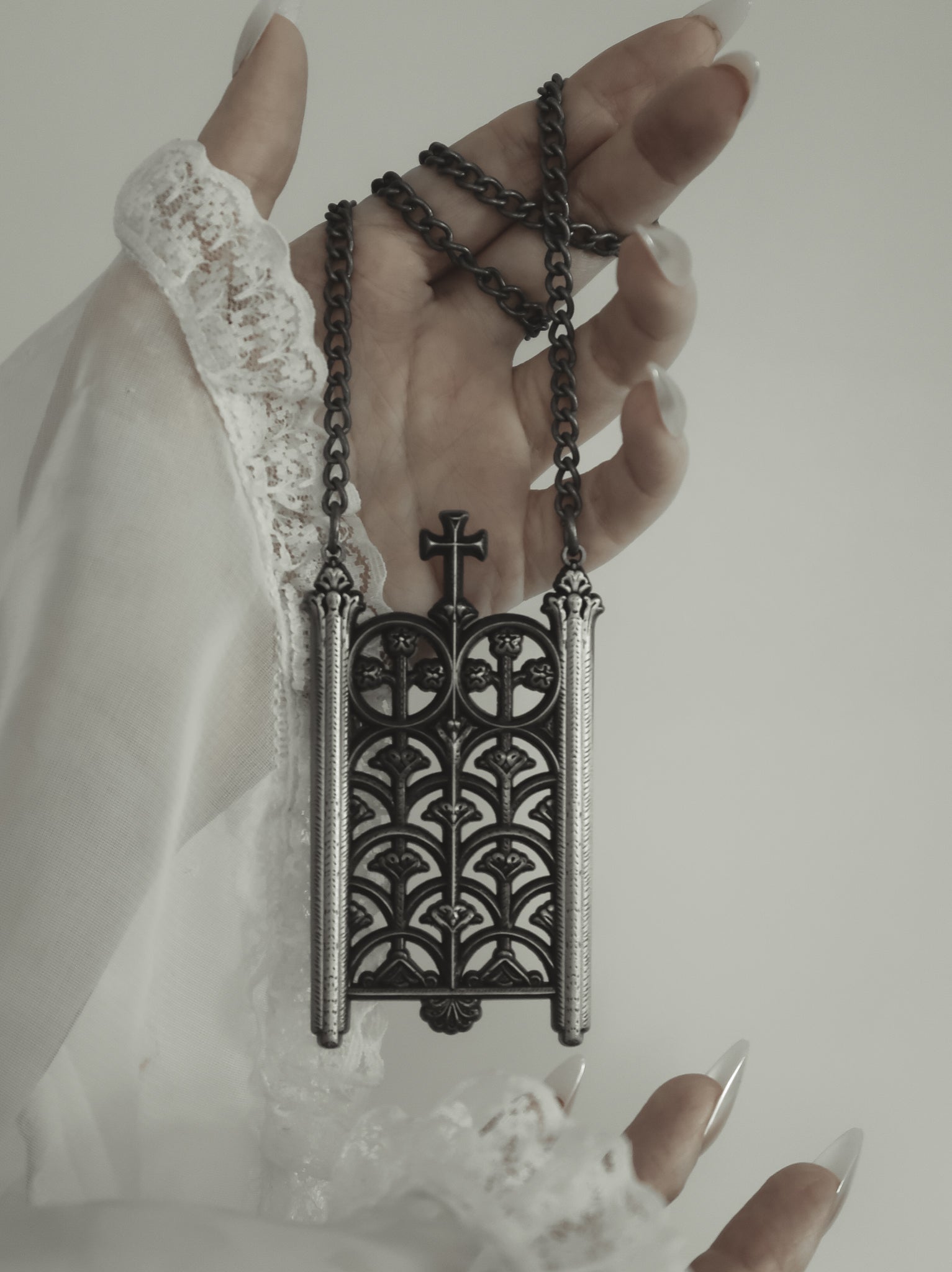 Model wearing the Rotunda Relic antique silver gate pendant