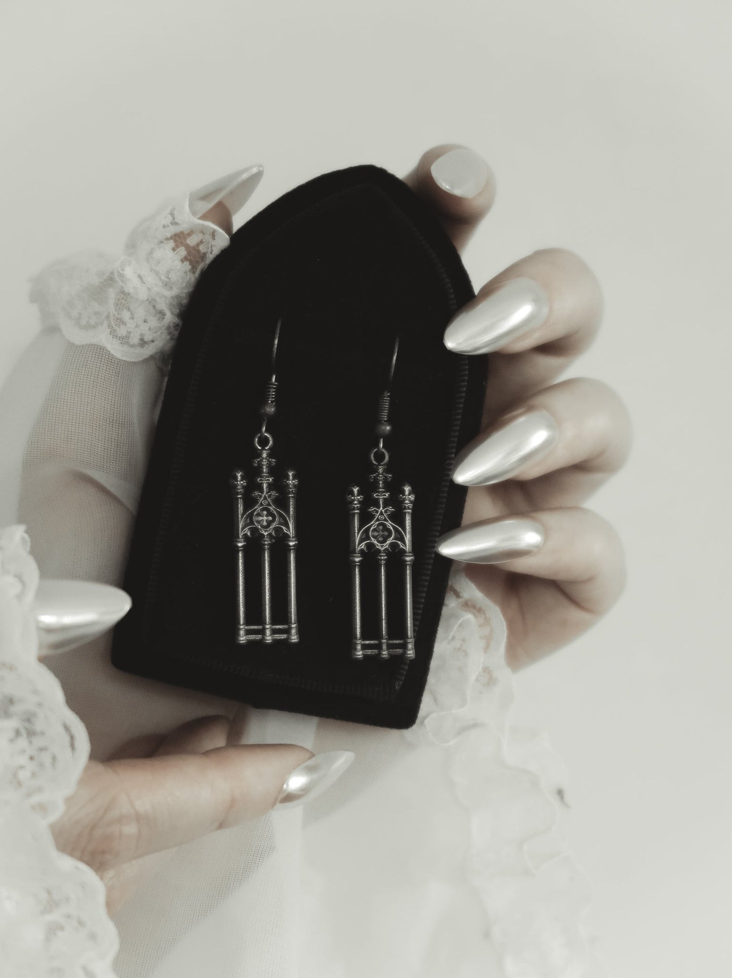 Cemetery Walks silver gate earrings held in hand, The Pretty Cult