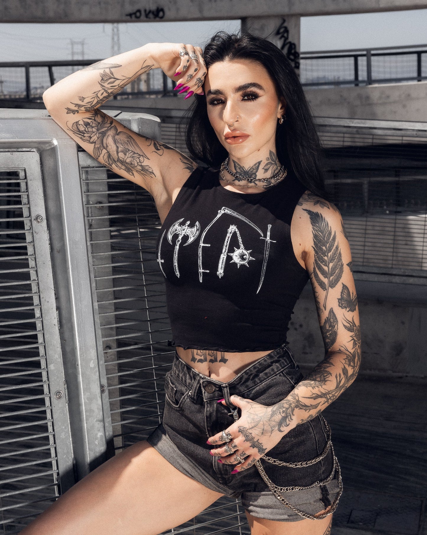Black cropped tank with white axe, stake and scythe line art