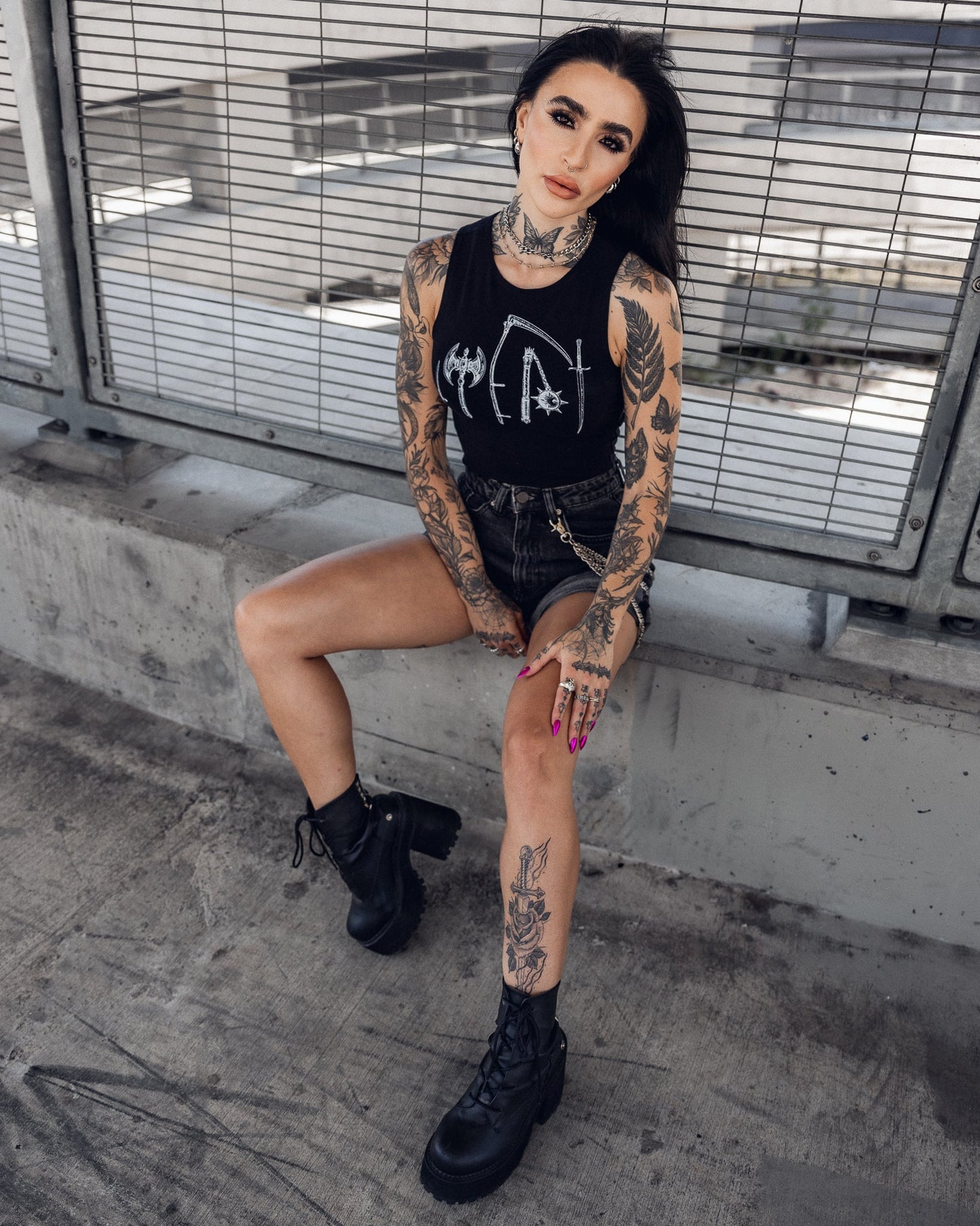 Sleeveless black crop top, side view