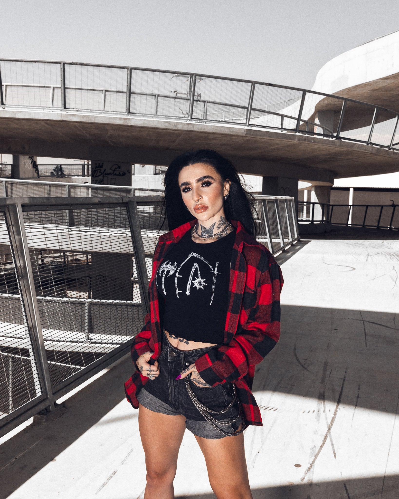 Fitted black crop top styled with high-waisted denim