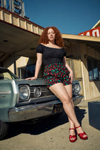 Pinup Girl Clothing black sateen peasant top and vintage cherries LB shorts editorial, sizes XS to 5X.