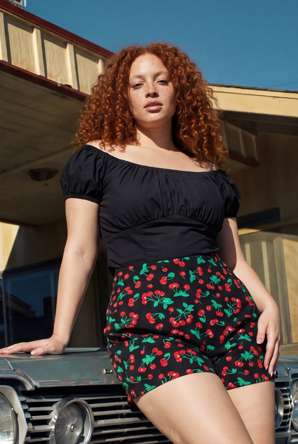 Pinup Girl Clothing black sateen peasant top styled with vintage cherries LB shorts, sizes XS to 5X.