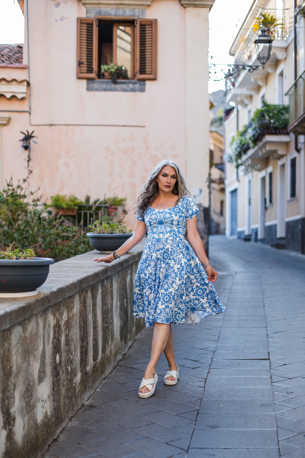 Amara swing dress in blue and white Noto Tile print with puff sleeves and a full swing skirt, by Pinup Girl Clothing