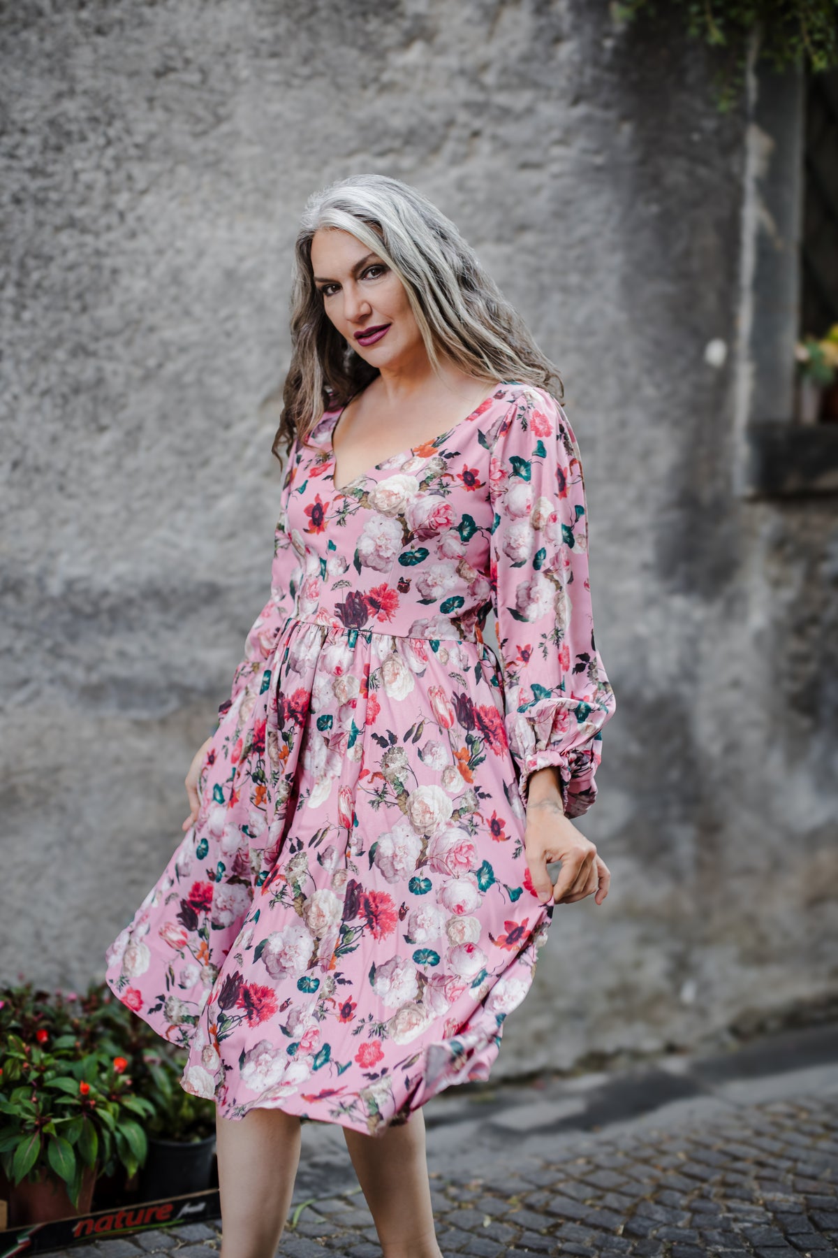 Kara swing dress in mauve Ambrosia Floral with a plunging V neckline and bell sleeves, by Pinup Girl Clothing