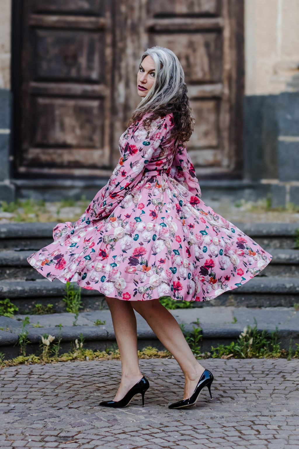 Kara swing dress in mauve Ambrosia Floral with a plunging V neckline and bell sleeves, by Pinup Girl Clothing