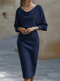 Model in the Silver Screen cowl-neck knit bodycon dress in navy blue, by Pinup Girl Clothing