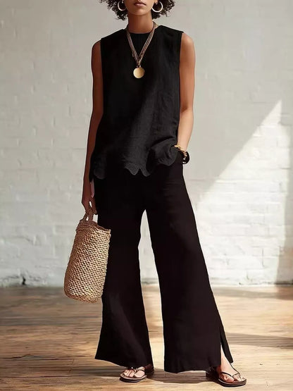 Odile scalloped hem sleeveless blouse in black, styled with wide-leg trousers, by Pinup Girl Clothing