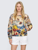 Model with one hand in the pocket of the oversized Bathing Clown Denim Jacket, buttoned, worn with white high-waisted shorts