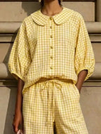 Bettina gingham set styled with flats and a shoulder bag, by Pinup Girl Clothing