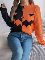 Carved two-tone pumpkin face sweater in black and orange
