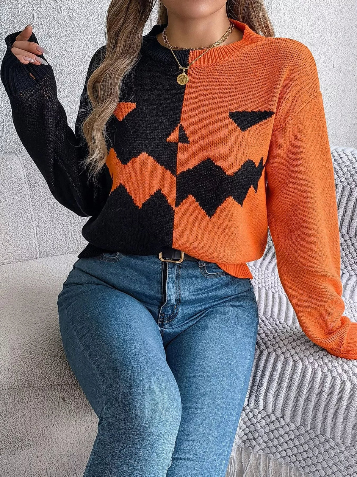 Carved two-tone pumpkin face sweater in black and orange