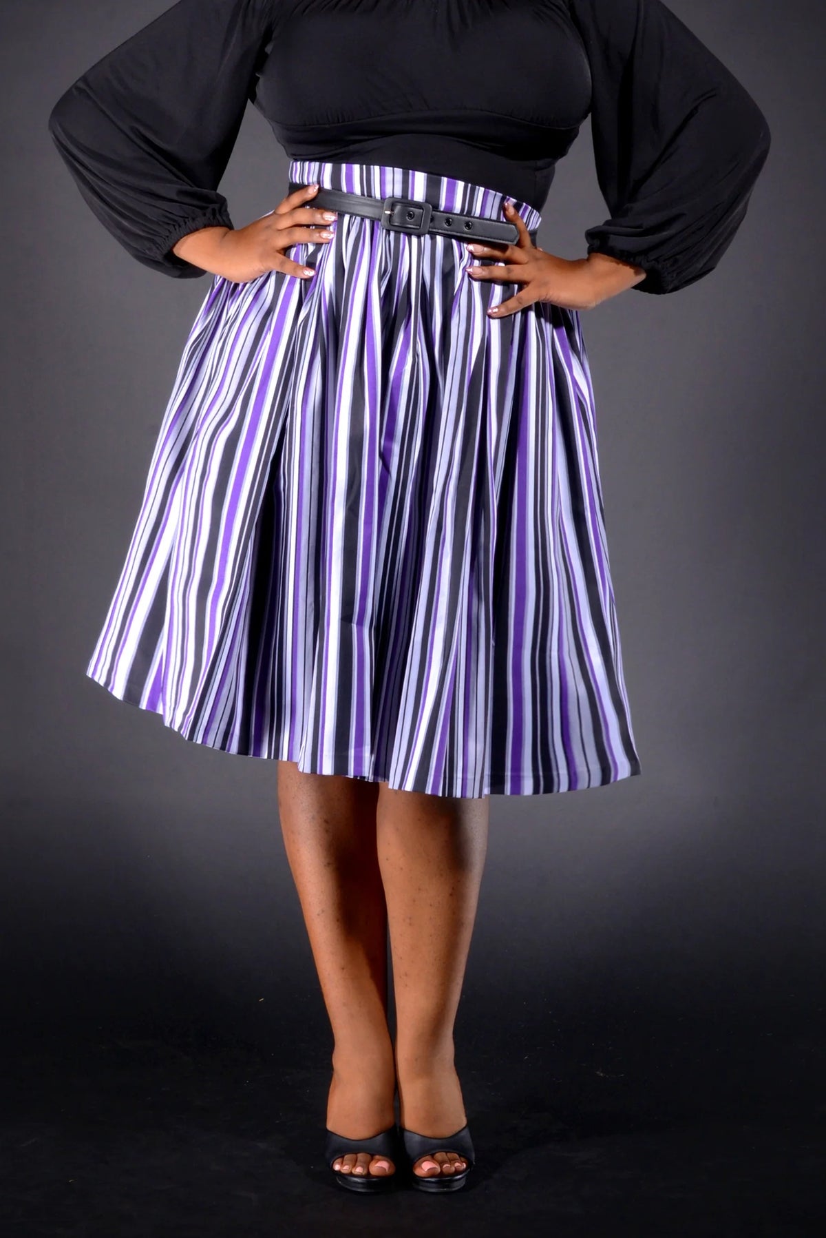 Waist-down view of the Bella swing skirt in purple Solstice Stripe sateen with black heels
