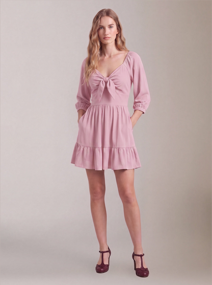 Molly Mini dress in Pinup Girl Pink worn with hands in the deep-set skirt pockets, by Pinup Girl Clothing.