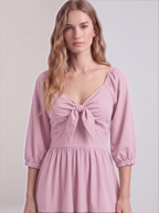 Close-up of the tie-front sweetheart bodice and elasticized sleeve cuffs on the Pinup Girl Pink Molly Mini dress.