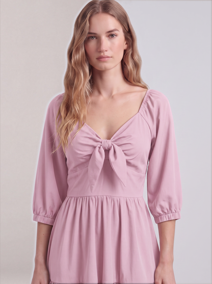 Close-up of the tie-front sweetheart bodice and elasticized sleeve cuffs on the Pinup Girl Pink Molly Mini dress.