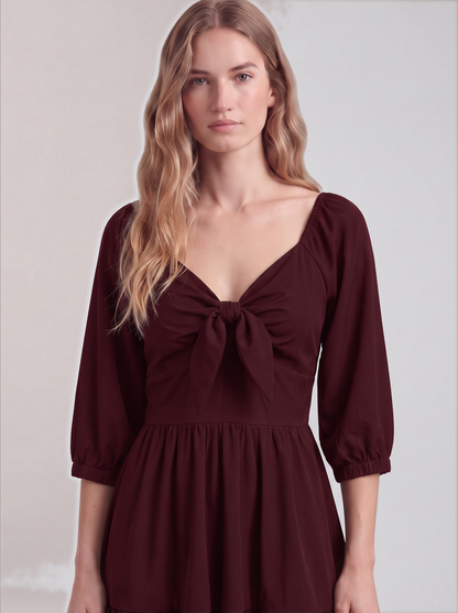 Close-up of the tie-front sweetheart bodice and elasticized sleeve cuffs on the burgundy Molly Mini dress.