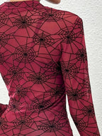 Close-up of the flocked spiderweb print on burgundy mesh
