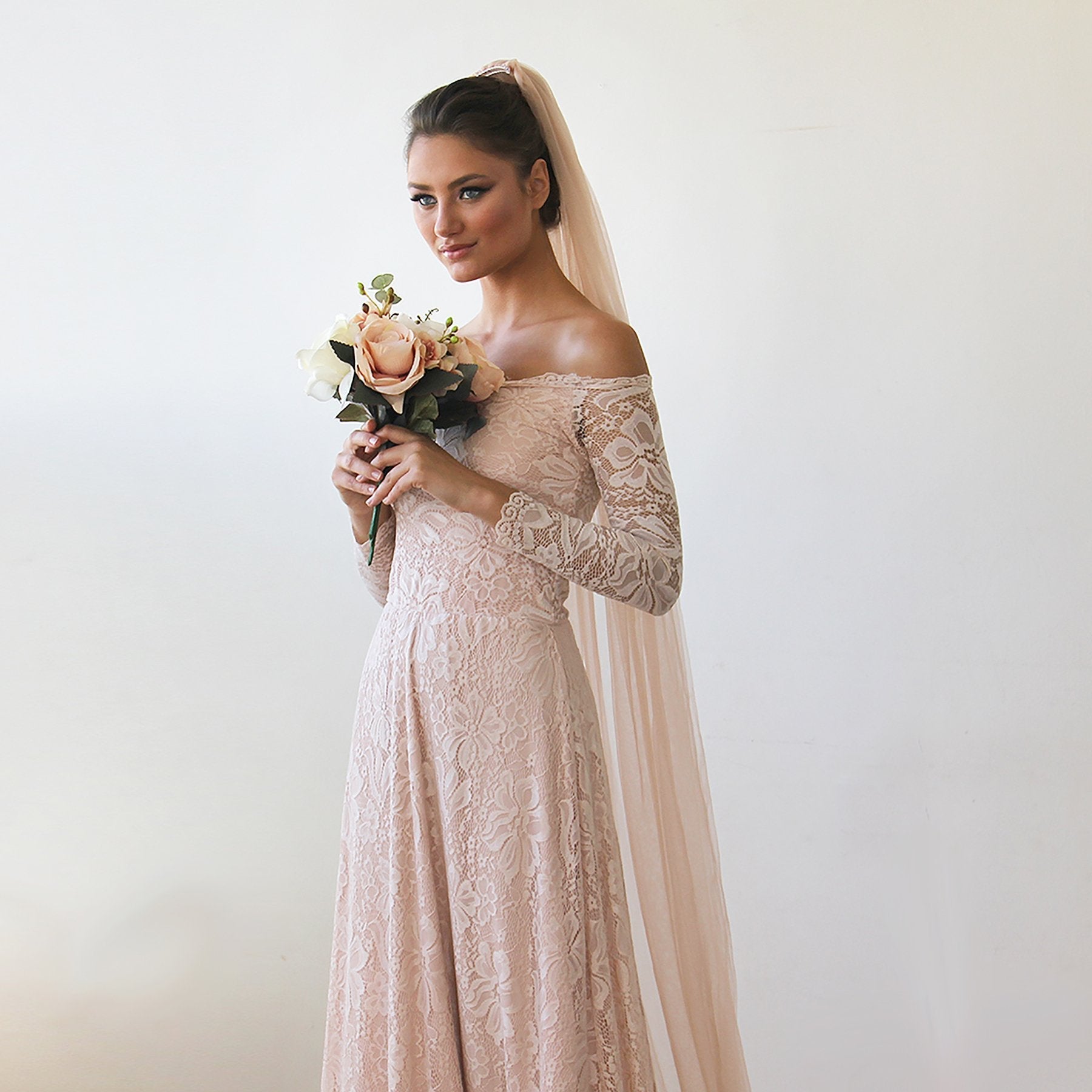 Blush tulle bridal veil from behind showing the floor-length drape