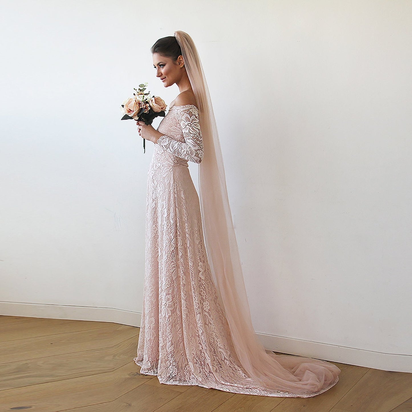 Blush cathedral length tulle bridal veil shown full length on the model