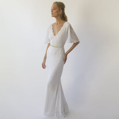 Model in the Delphine ivory lace sheath gown with V neckline and butterfly lace sleeves