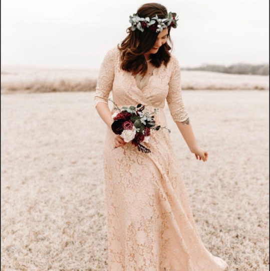 Ondine blush lace gown, front view showing the wrap bodice and floor-length skirt