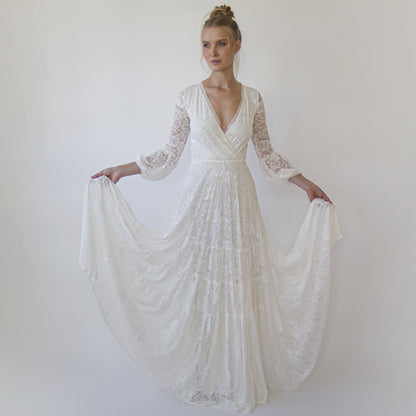 Model in the Juniper ivory lace wrap gown with fringed V neckline and three-quarter bracelet sleeves