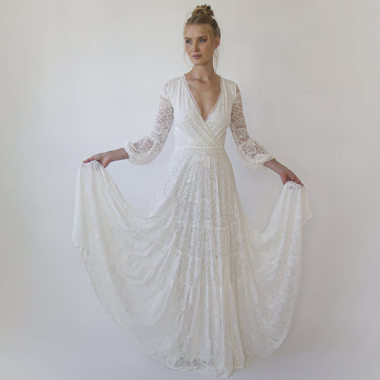Model in the Juniper ivory lace wrap gown with fringed V neckline and three-quarter bracelet sleeves