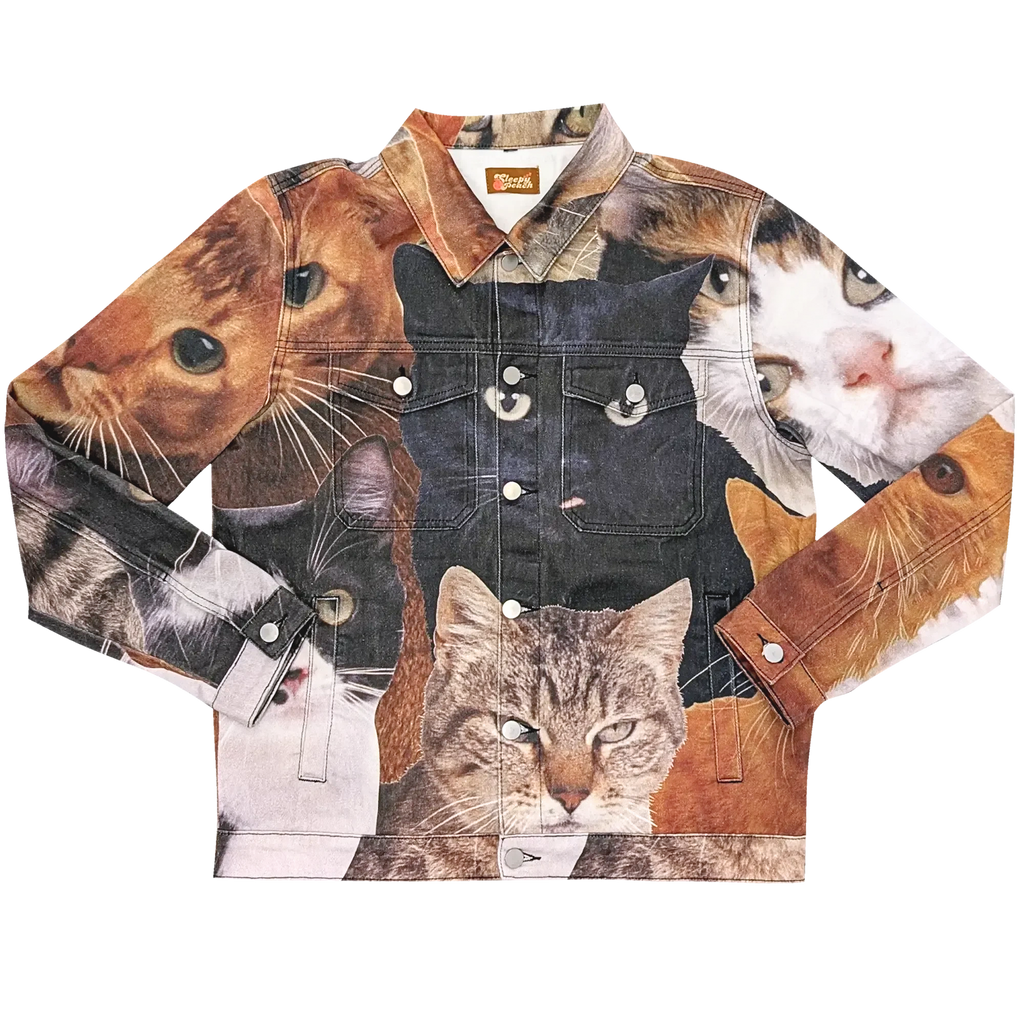 Cat Wrangler Denim Jacket laid flat, denim printed with a photo collage of cat faces: a black cat, tabbies and orange cats