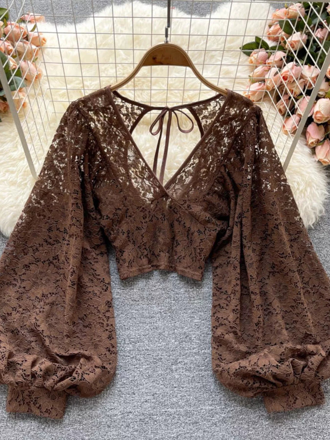 Lace tie-back long-sleeve top in curry by Pinup Girl Clothing.