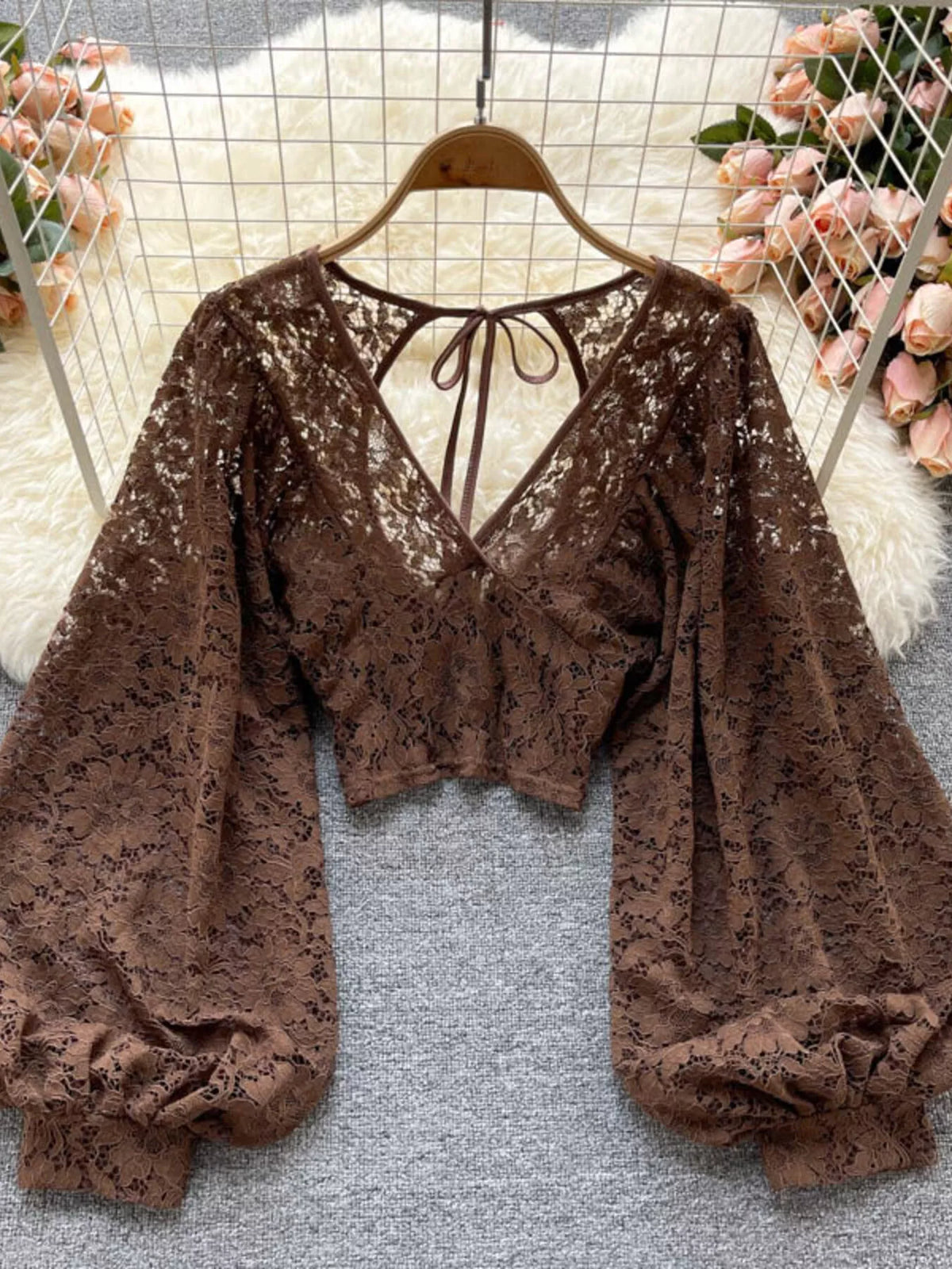Lace tie-back long-sleeve top in curry by Pinup Girl Clothing.