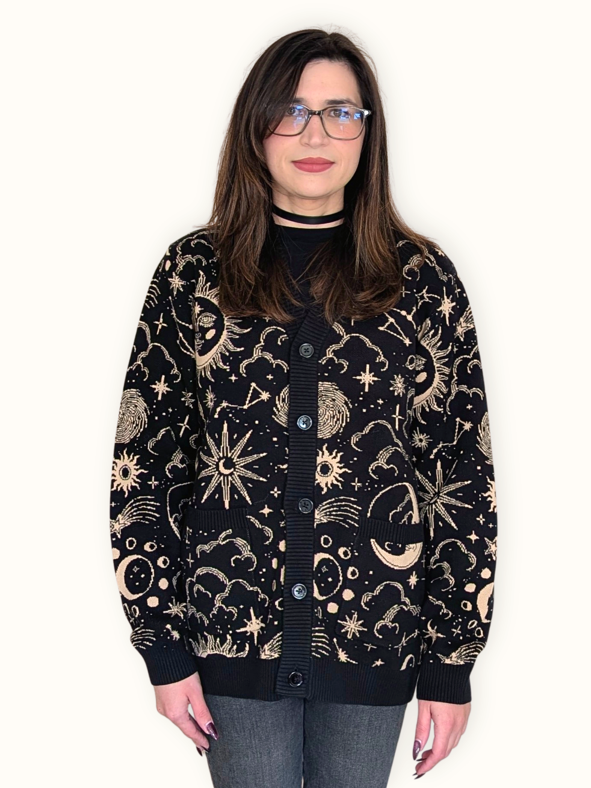 Woman wearing the Celestial Cardigan buttoned up, black knit with cream sun and moon print