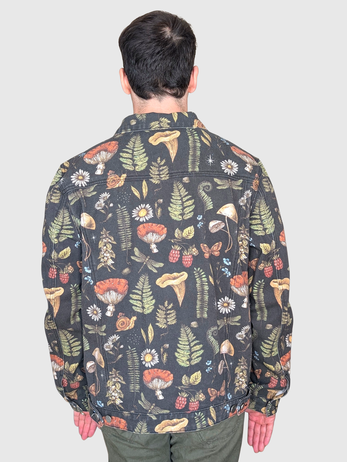 Back view of the Cottagecore Essentials Denim Jacket showing the all-over mushroom, fern and moth print