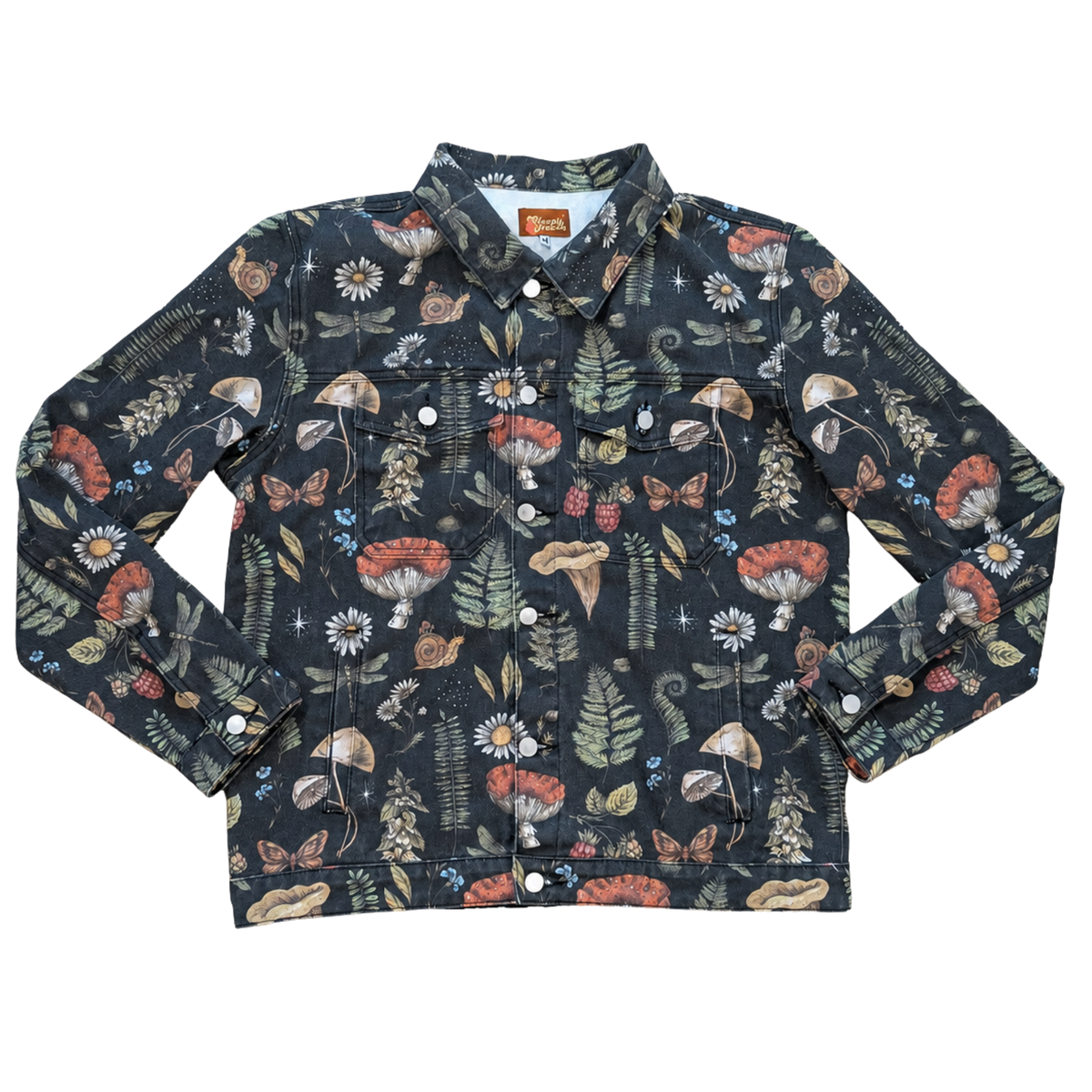 Cottagecore Essentials Denim Jacket laid flat, vintage washed black denim with an all-over mushroom, fern and moth print and metal buttons