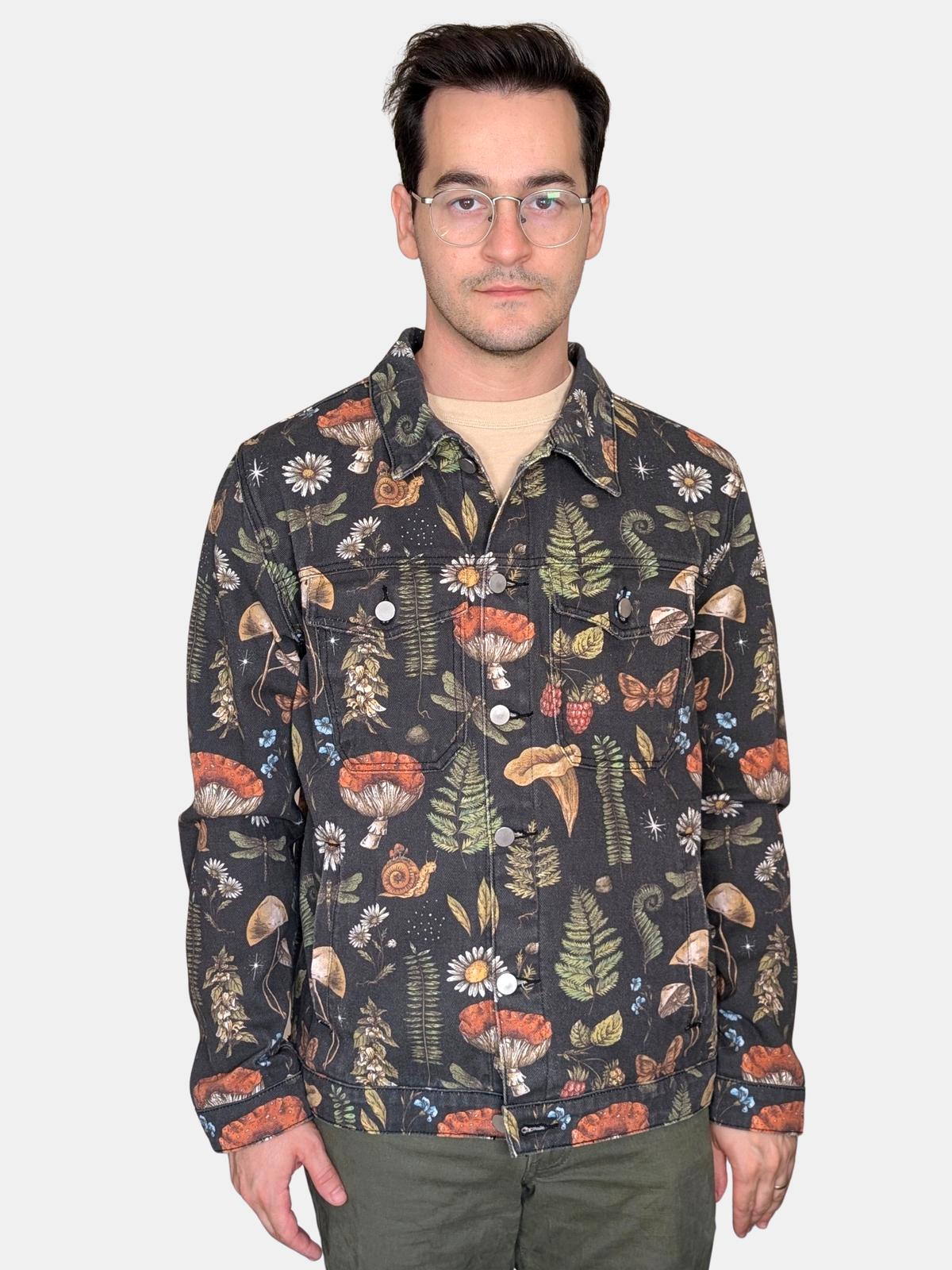 Front view of the Cottagecore Essentials Denim Jacket buttoned up, black denim with mushroom and fern print and two chest pockets