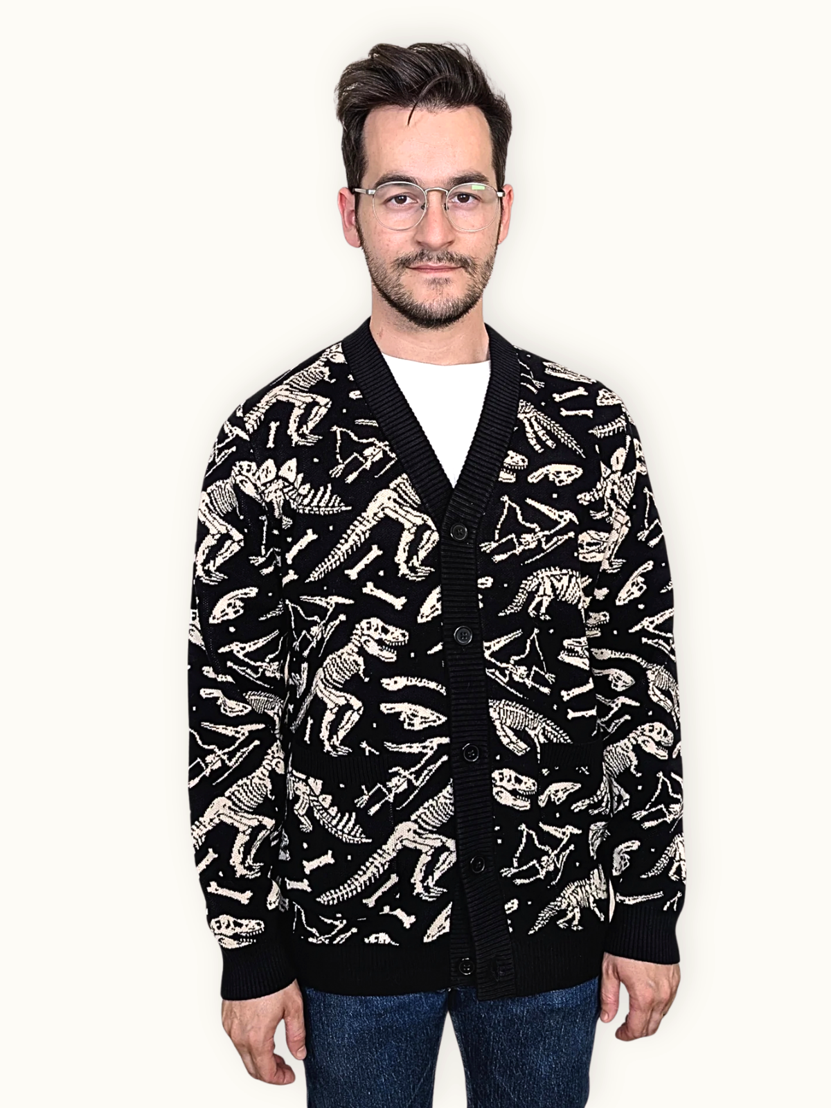 Front view of the Dinosaur Fossil Cardigan buttoned up, cream fossil print on black knit
