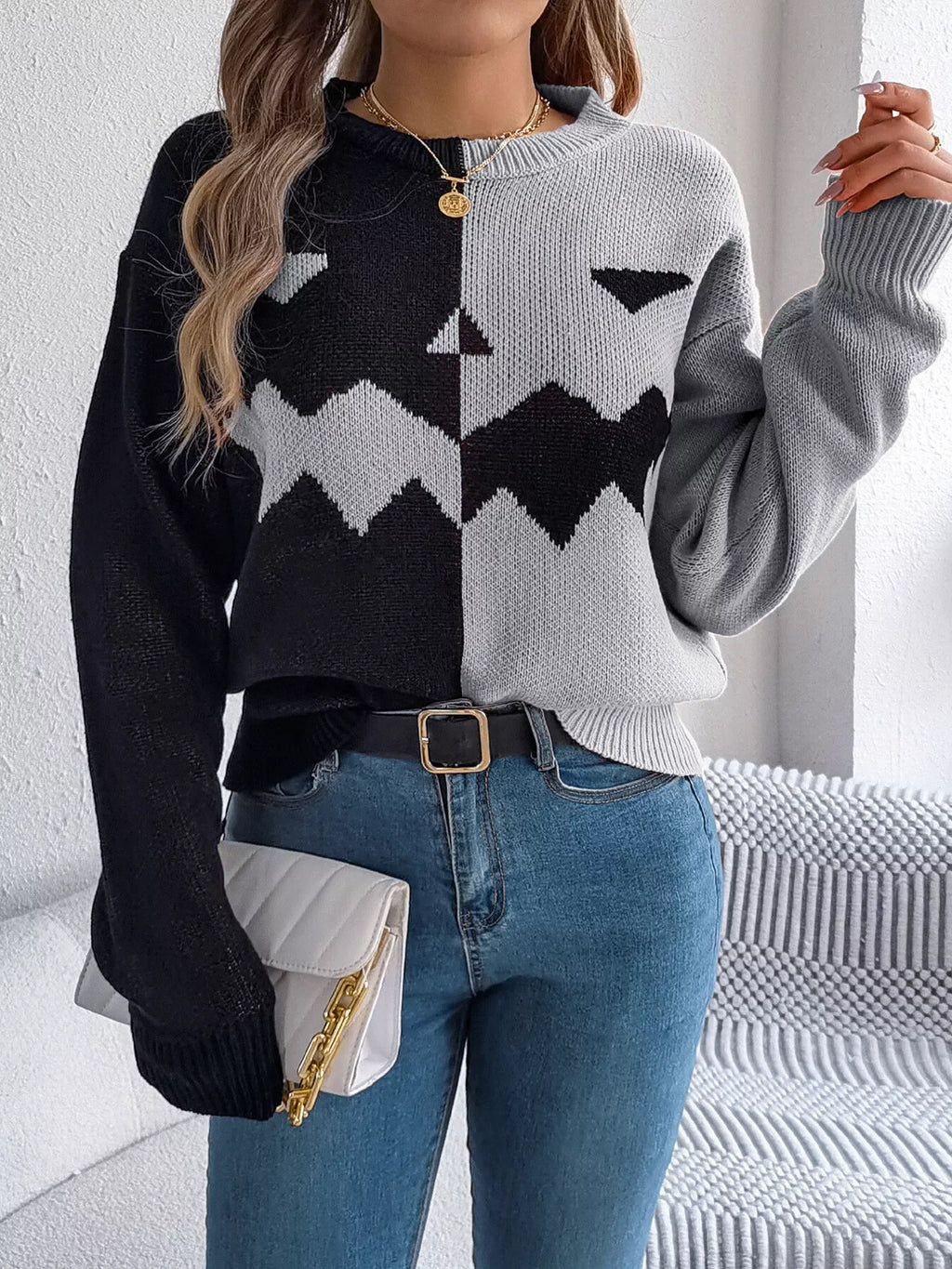 Carved two-tone pumpkin face sweater in black and gray