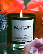 Fantasy candle lit among bright orange and pink flowers