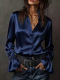 Champagne Belle flounce-sleeve blouse in navy by Pinup Girl Clothing.