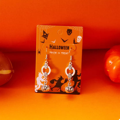 Silver skull and lantern dangle earrings shown worn