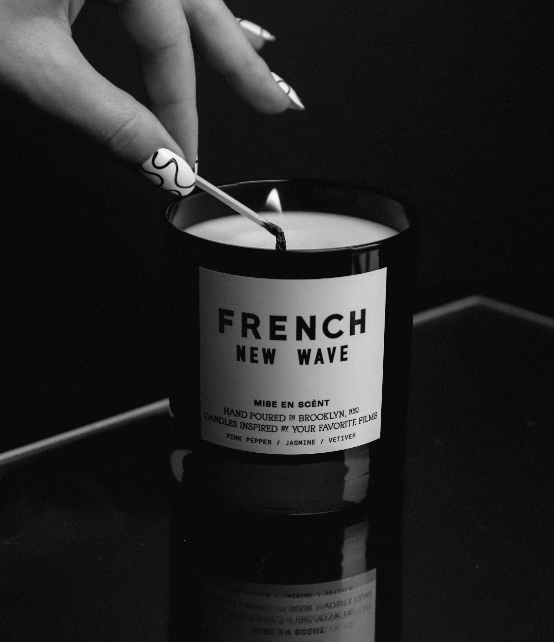 French New Wave candle being lit, in black and white