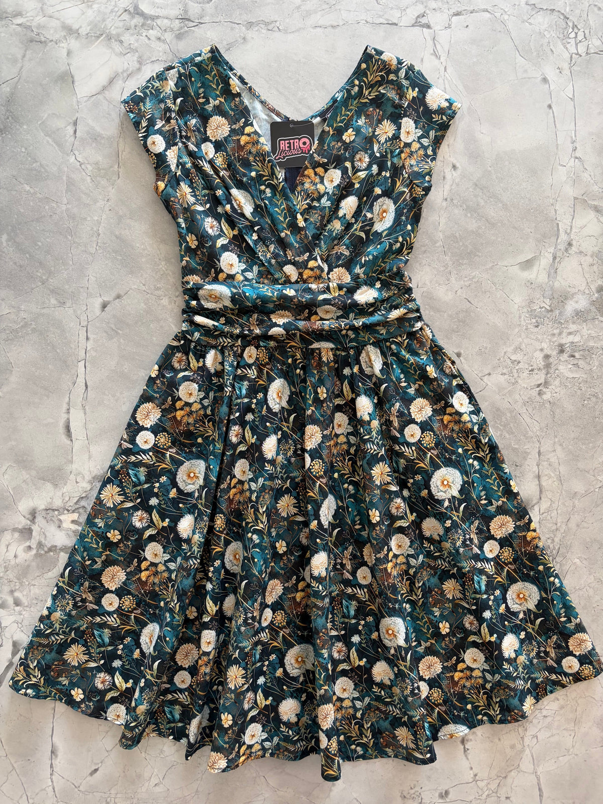 Dandelions Greta Dress, a green floral 1950s swing dress with a surplice neckline