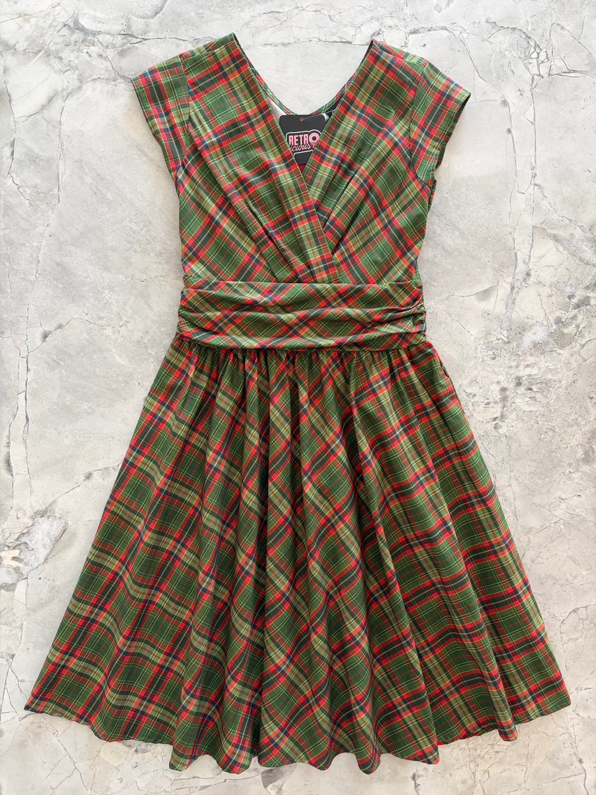 Green Plaid Greta Dress, a green and red plaid 1950s swing dress with a surplice neckline
