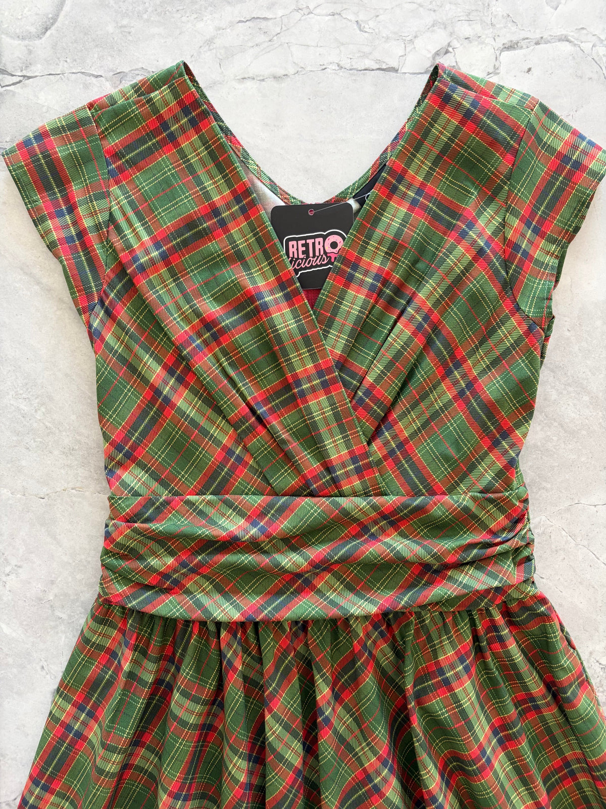 Green Plaid Greta Dress, a green and red plaid 1950s swing dress with a surplice neckline