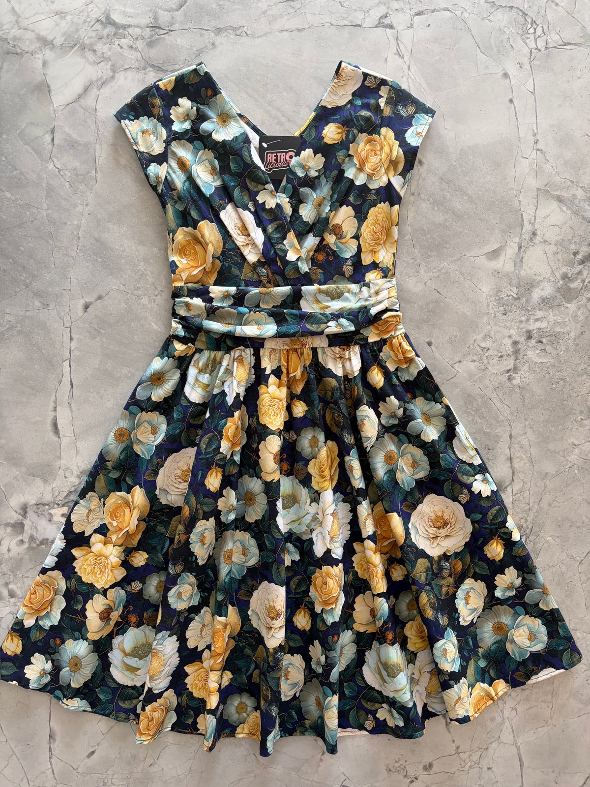 Midnight Floral Greta Dress, a black floral 1950s swing dress with a surplice neckline